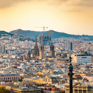 A breathtaking aerial view of Barcelona featuring the iconic Sagrada Familia at sunset.