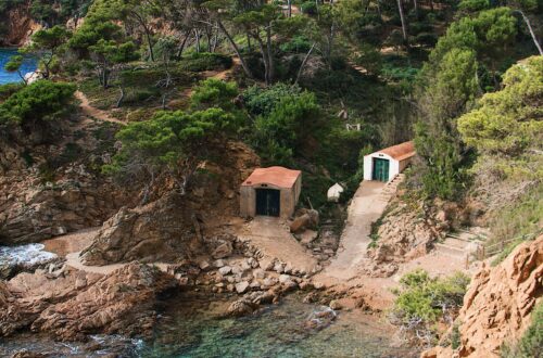 Cala dels Canyers cove with clear waters and rocky landscape in Girona, Spain.