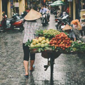 A woman sells fresh fruits in a Đống Đa street market, Hanoi, Vietnam.