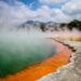 Stunning geothermal Champagne Pool with vivid colors and steam at Wai-O-Tapu, New Zealand.