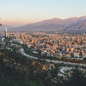 Breathtaking view of Santiago, Chile's skyline framed by mountains at sunset.