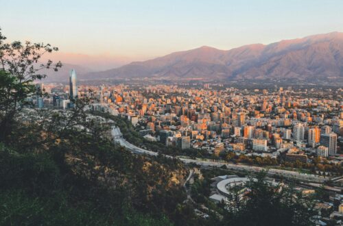 Breathtaking view of Santiago, Chile's skyline framed by mountains at sunset.