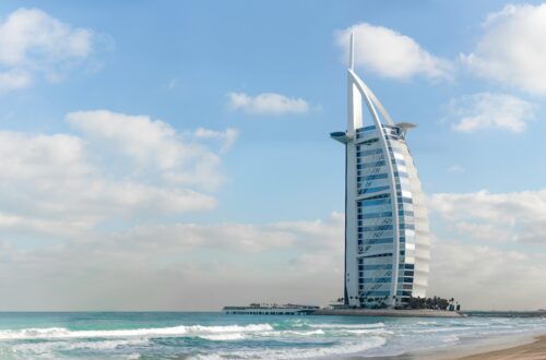 Stunning view of Burj Al Arab with a serene beach setting in Dubai, UAE.