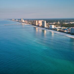 Stunning aerial view of Panama City Beach's coastline with clear blue waters and skyscrapers in view.