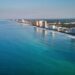 Stunning aerial view of Panama City Beach's coastline with clear blue waters and skyscrapers in view.