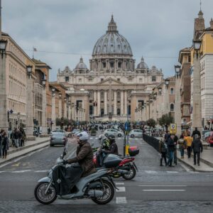 St. Peter's Basilica view with vibrant street life, Rome.