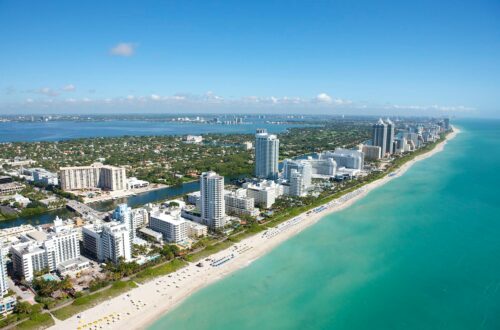 Stunning aerial view of Miami Beach's skyline along the Atlantic Ocean, ideal for travel and adventure imagery.