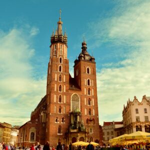 Vibrant view of St. Mary's Basilica in Krakow's bustling main square.