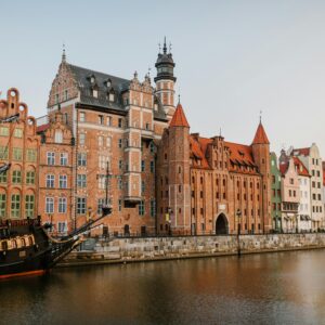 Scenic view of colorful historic buildings along the Motława River in Gdańsk, Poland.
