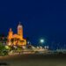 Capture of the illuminated church and promenade by the beach in Sitges, Spain at night.