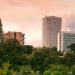 View of modern skyscrapers and lush greenery in Tirana, Albania during daylight.