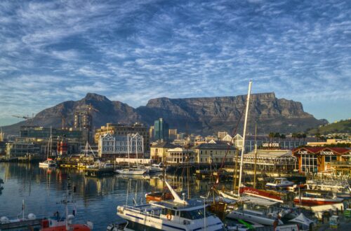 Stunning view of Cape Town harbor with boats and iconic Table Mountain backdrop.