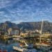 Stunning view of Cape Town harbor with boats and iconic Table Mountain backdrop.