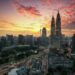 A breathtaking view of Kuala Lumpur's skyline featuring the Petronas Twin Towers at sunset.